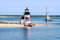 Sailing Past Lighthouse on Nantucket Island on a Summer Day